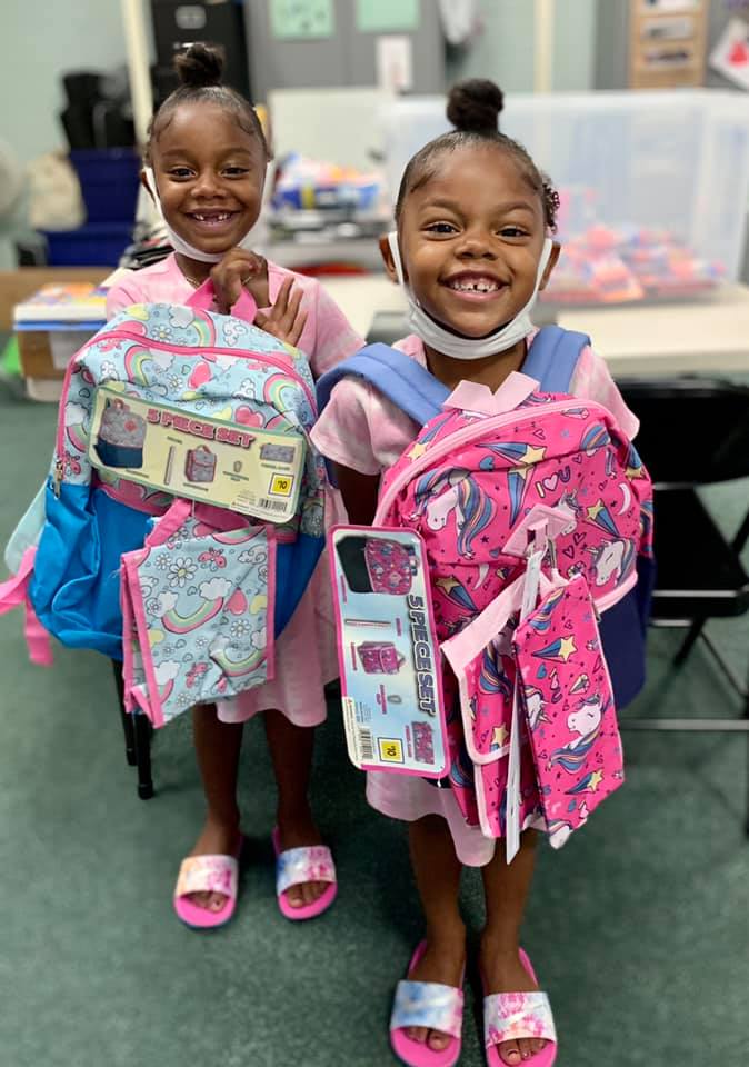 2 Girls Holding Book bags